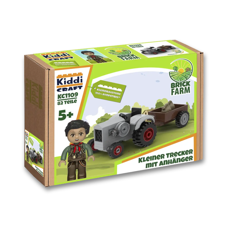 Ein Trekker Traktor aus Klemmbausteinen mit Anhänger und eirner Spielfigur